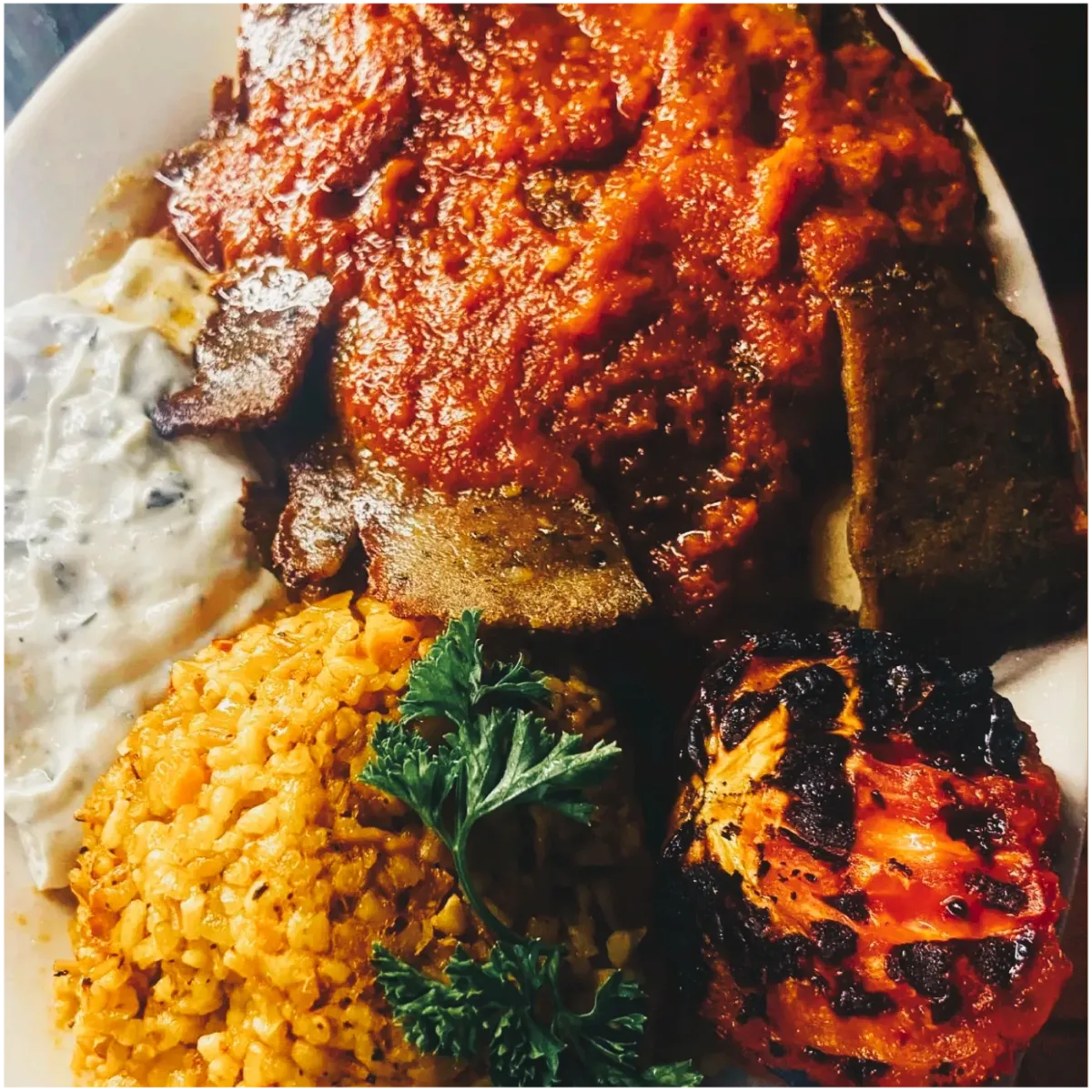 Mediterranean grilled meat with rice, tomatoes, and tzatziki at Anatolia Cafe