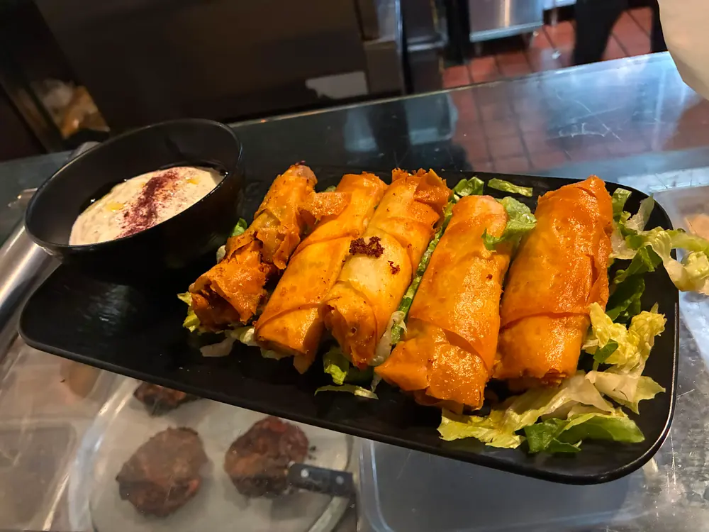 Crisp golden rolls with a creamy dip and greens
